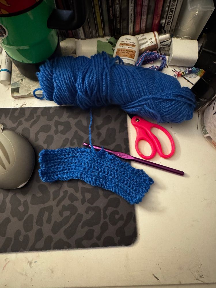  Work in progress of a blue scarf sitting on a messy desk