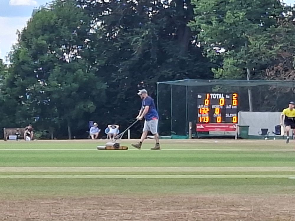 A groundsman rolls the pitch at Falkland CC in Newbury