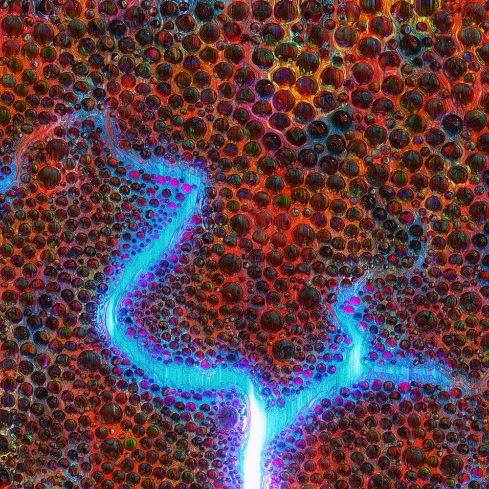 a landscape of multicoloured, distorted spheres, with a giant blue fissure.