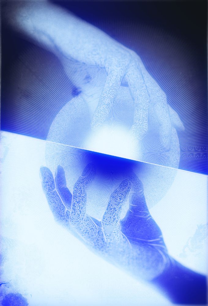 line art of two hands, one inverted, their fingers manipulate the same sphere of light