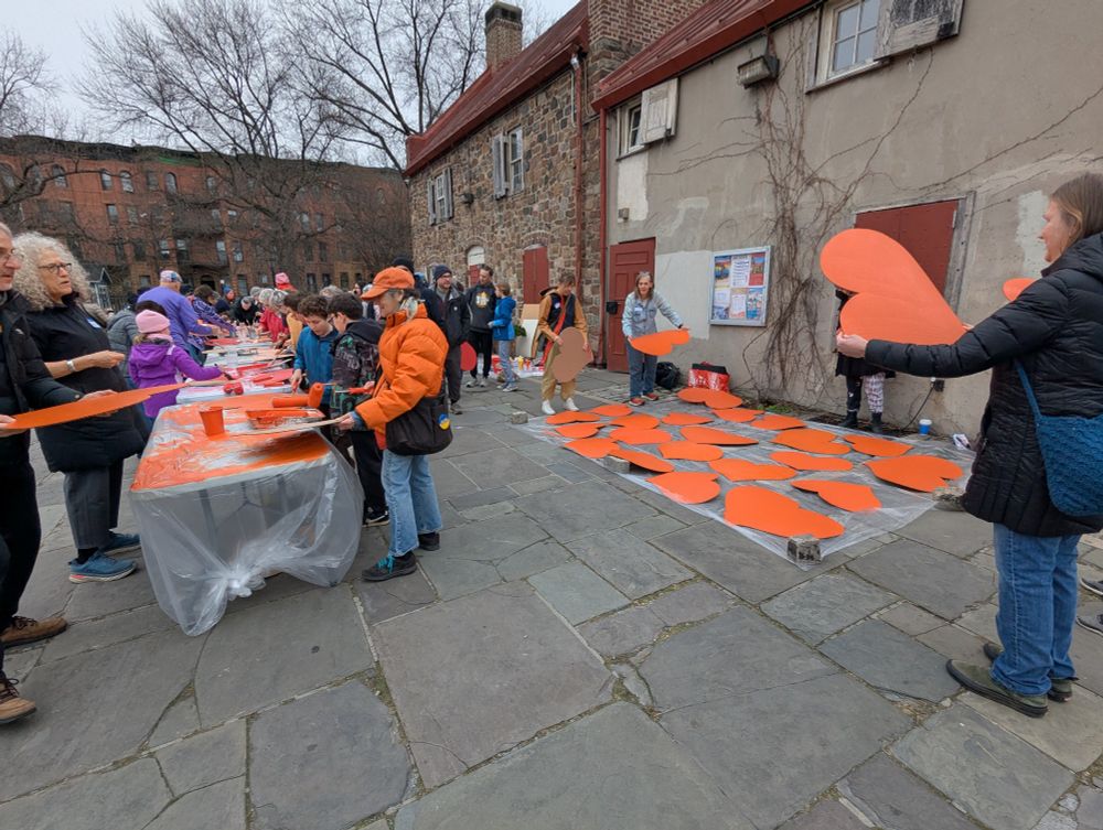 Group painting cardboard hearts in Brooklyn 

