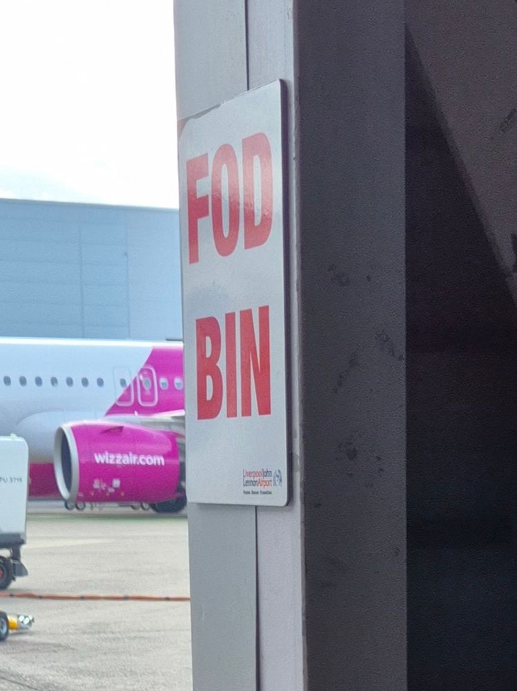 A sign saying "FOD BIN". 

(There is an aeroplane in the background, because it's at an airport) . 