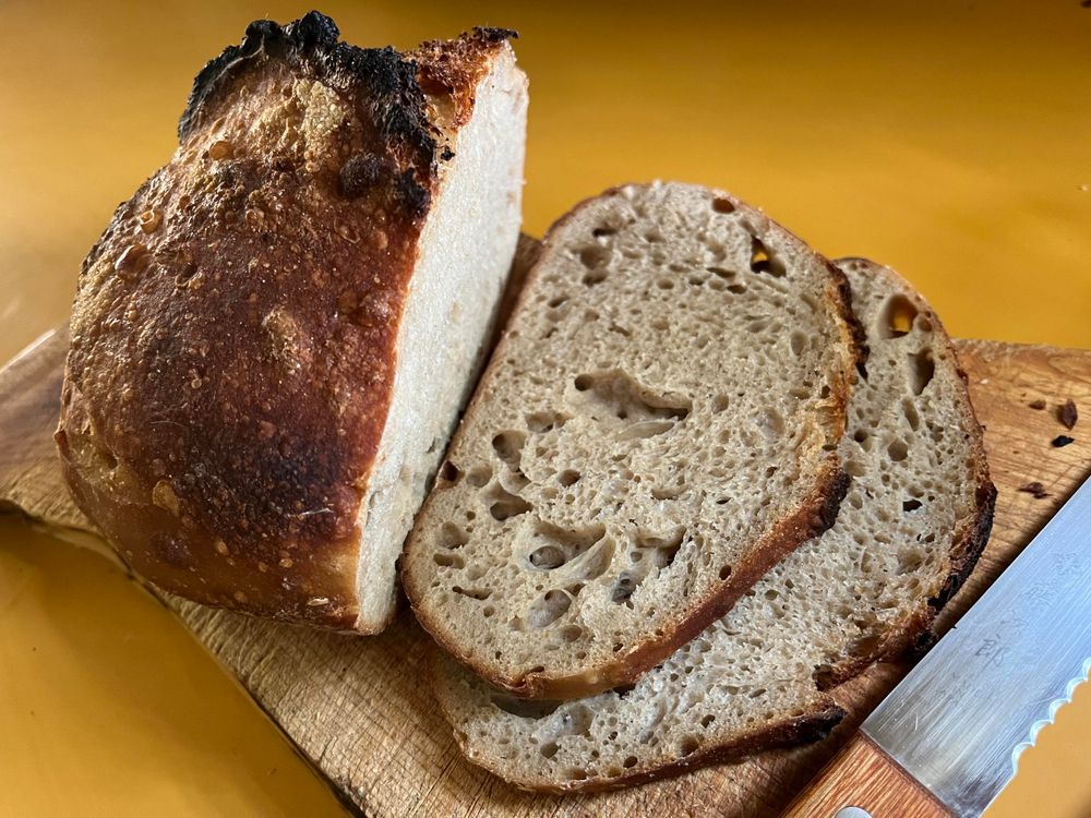 Half a loaf of sourdough bread and a couple of slices.