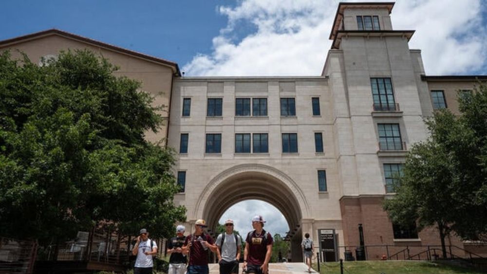 Students walk on campus at Texas State University in San Marcos, Texas.