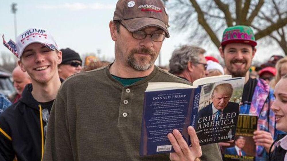 Person reading a book by Donald Trump