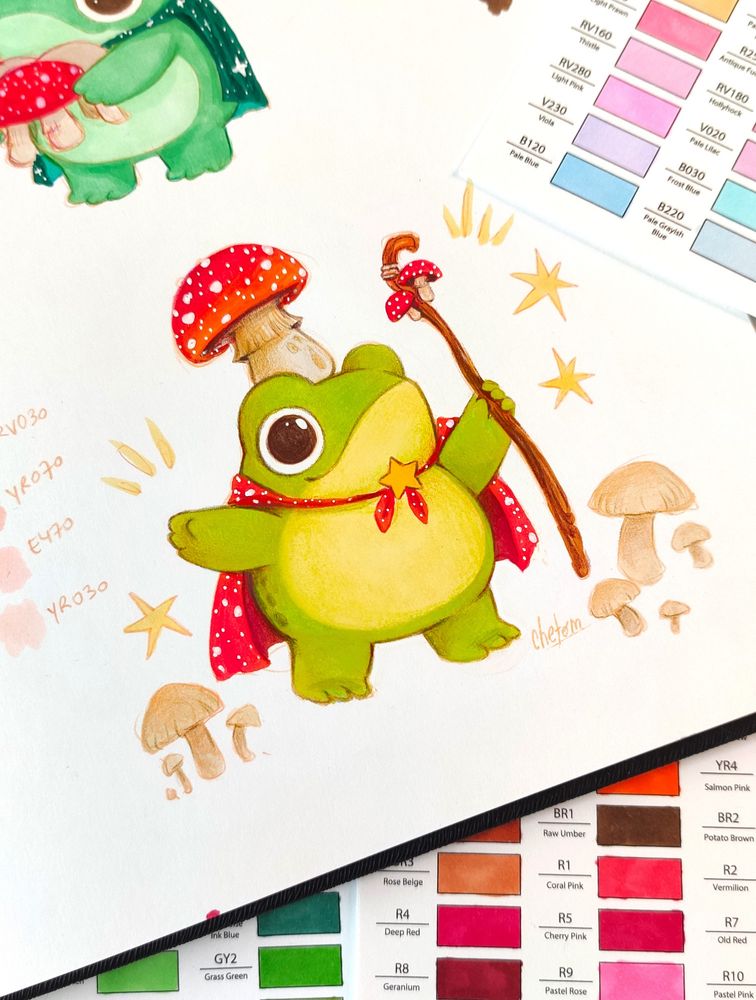 cute whimsical colorful traditional artwork of a frog wearing a mushroom hat and cape. wizard frog art painted with markers and colored pencils illustrated by chetom