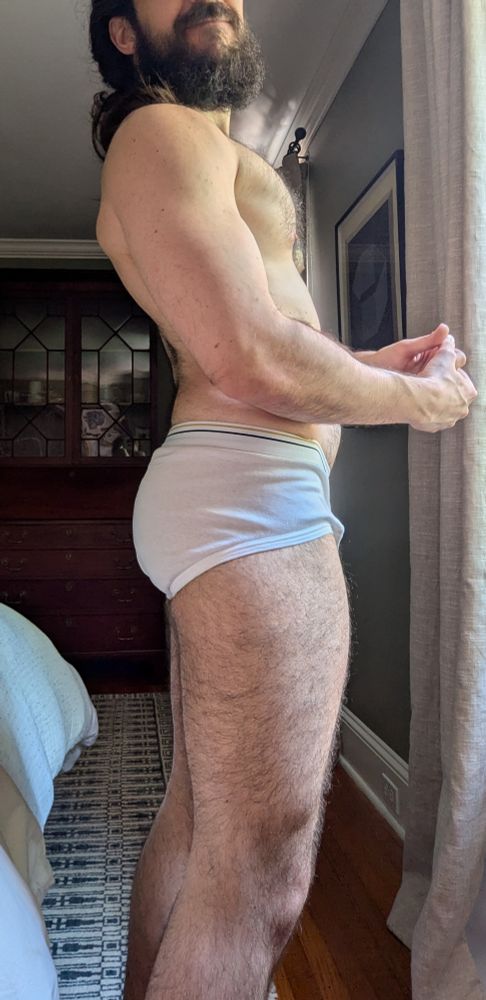 Side profile in white briefs. 