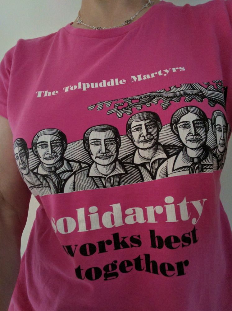 Pink t-shirt featuring faces of the Tolpuddle Martyrs with the slogan: Solidarity works best together.