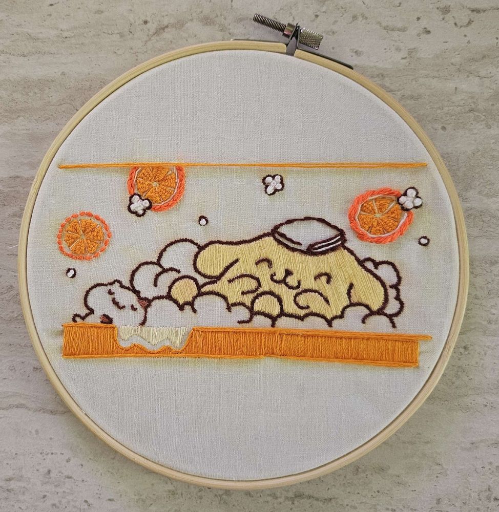 hand embroidery of Pompompurin taking a citrus bath