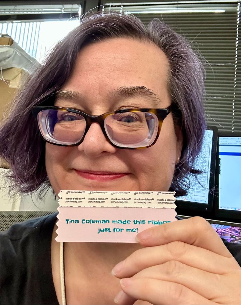 Tina Coleman holds a ribbon that reads: Tina Coleman made this ribbon just for me. 