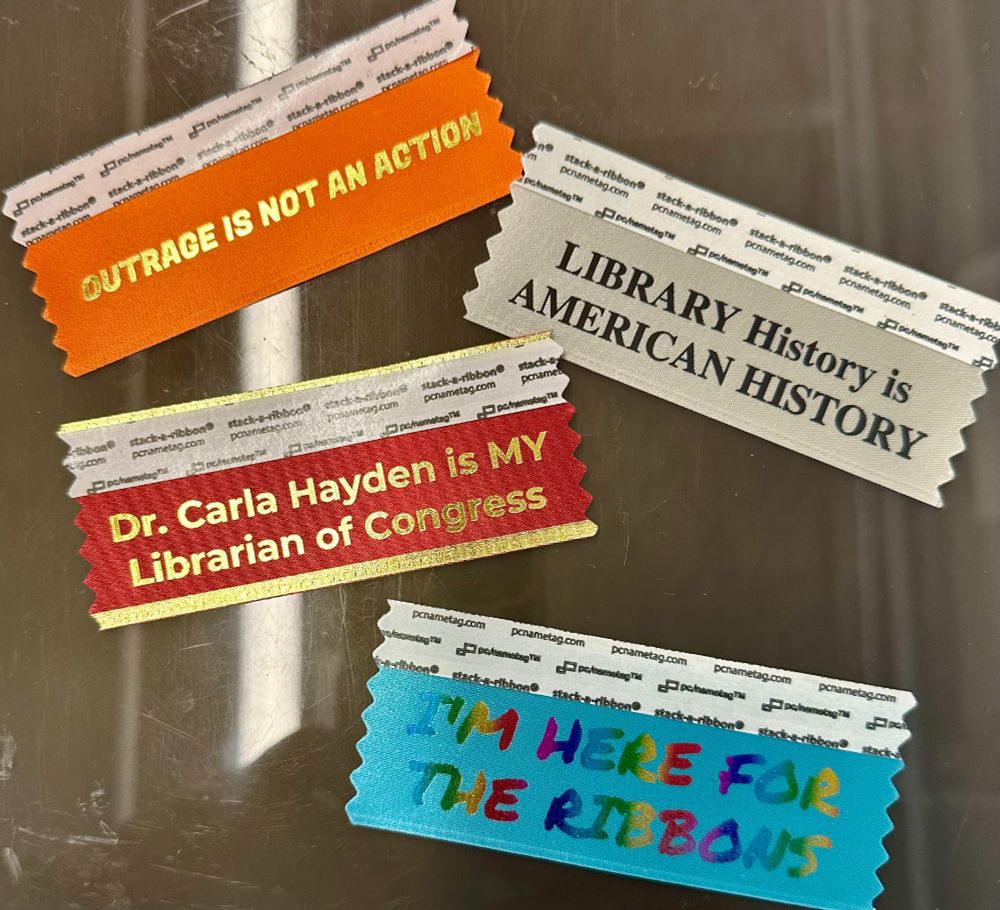 Badge ribbons:
Outrage is not an action; Library history is American history; Dr. Carla Hayden is my Librarian of Congress; I'm here for the ribbon. 