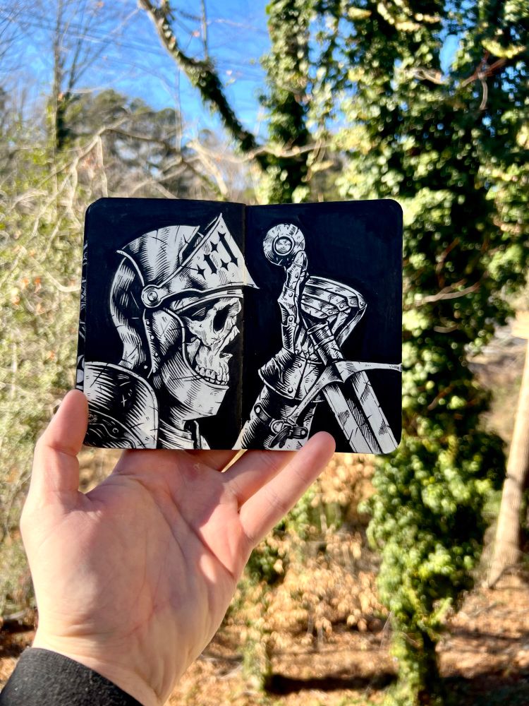 Hand holding sketchbook containing a skeleton in a suit of armor holding a sword. Knight, sword, ink drawing, sketch, drawing, draw, art