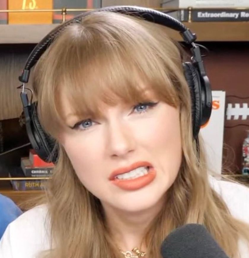 Taylor Swift making a cringe uhh face like not sure what to think about this wearing headphones and a mic is in front of her on the new heights podcast