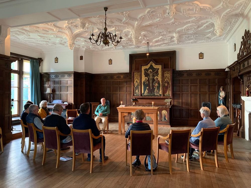 A group of people sitting in a circle in an ornate chapel