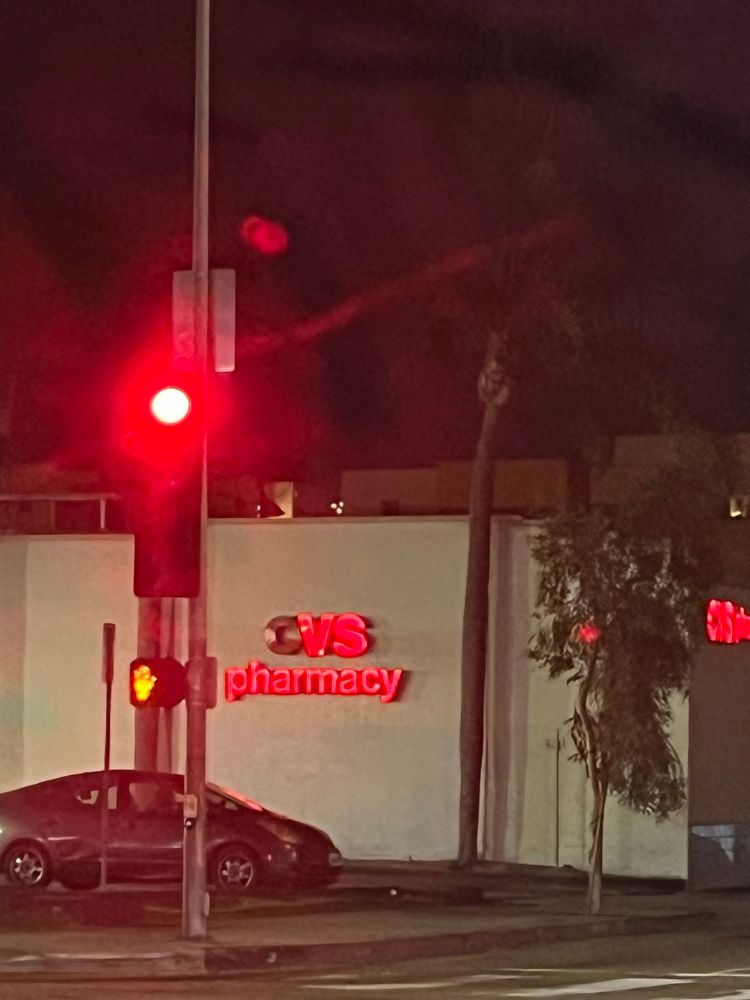 Photo of a CVS Pharmacy sign with the light on the C burnt out