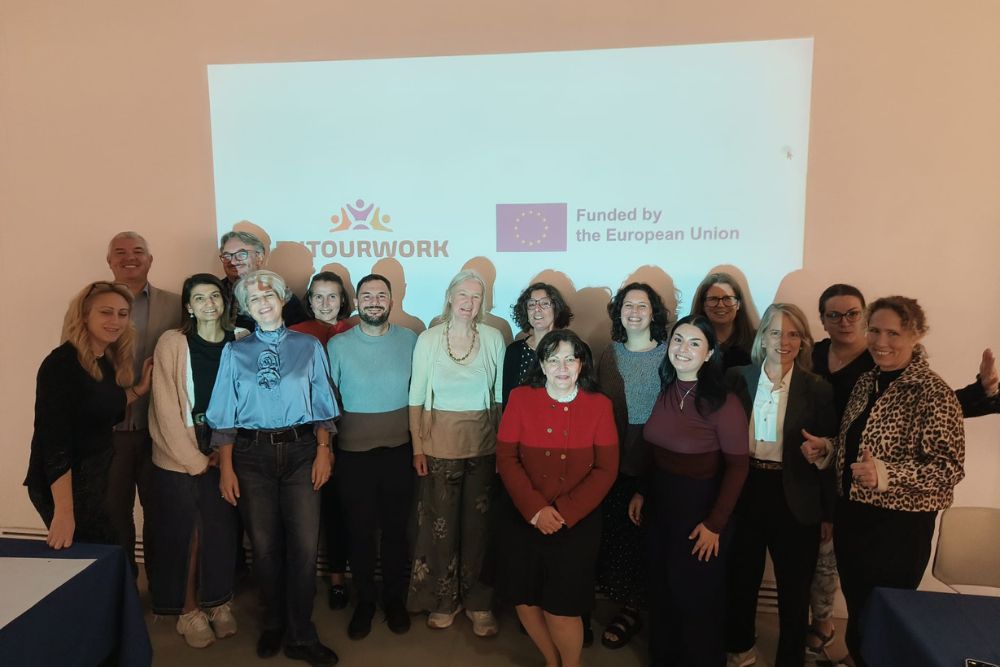 Team members from FUTOURWORK standing in front of the project and EU logos