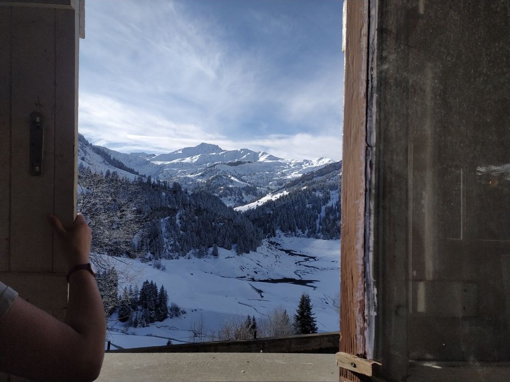 Un paysage par la fenêtre. De belles montagnes enneigées sous le soleil d'hiver.