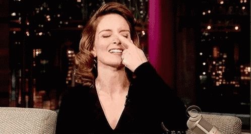 Tina Fey taps her own nose.