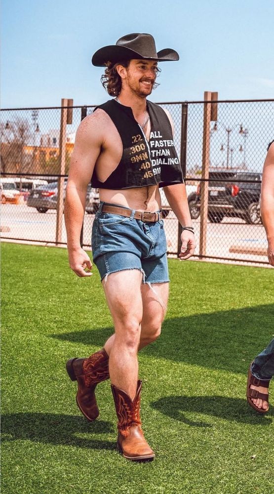 Mets pitcher Nolan McLean is daisy dukes, cowboy boots, a crop top, and cowboy hat