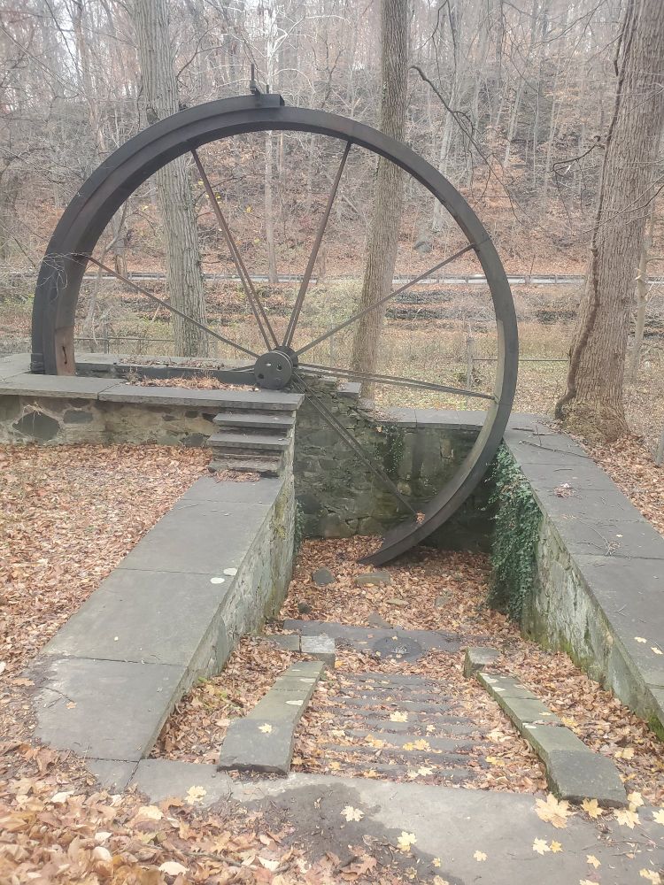 An old water wheel made of iron.