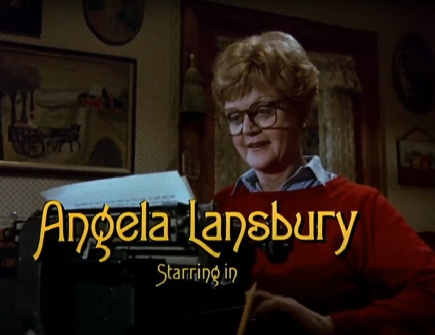 J. B. Fletcher in a red sweater sitting at a typewriter in her quaint living room. Text: "Angela Lansbury Starring in"
