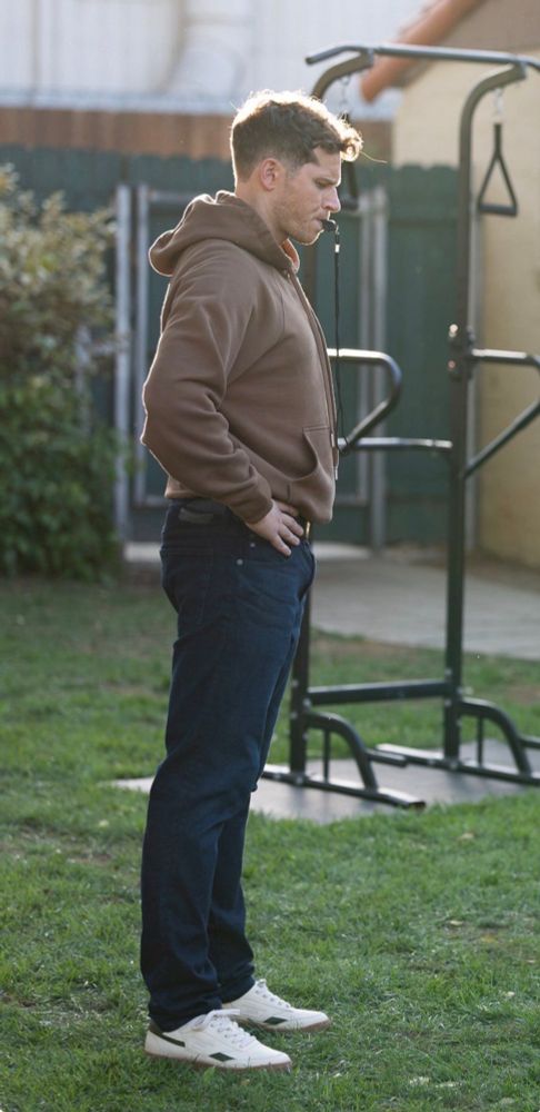 evan “buck” buckley in brown hoodie with a whistle