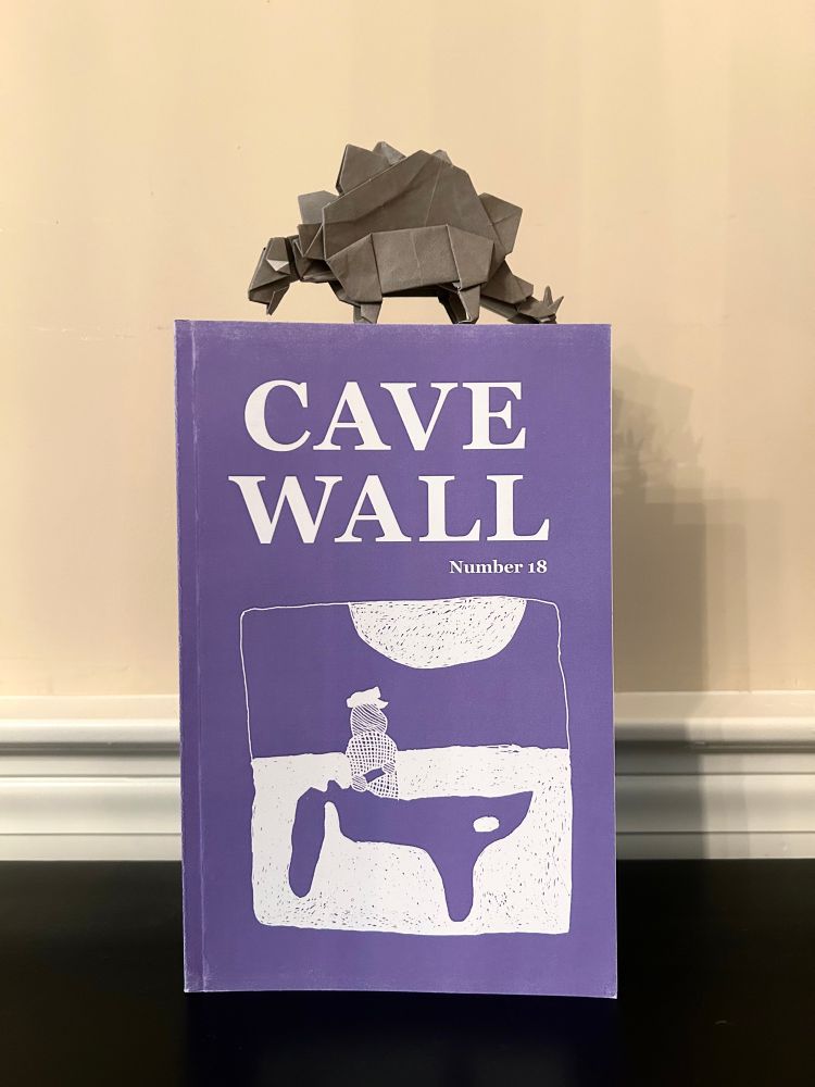 Cover of Cave Wall #18 and an origami stegosaurus. 