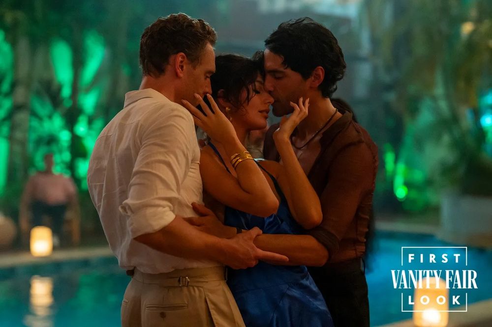 Tom Hiddleston in The Night Manager dancing closely with a woman and another man. 