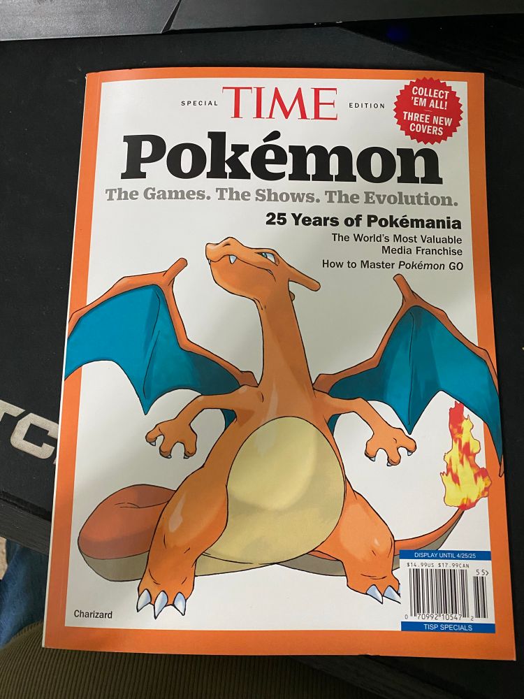 A Time Magazine all about Pokémon. The front shows the orange fire type Pokémon, Charizard, with his wings out.