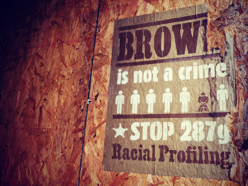 wheat paste sign that says Brown in not a crime; Stop Racial Profiling