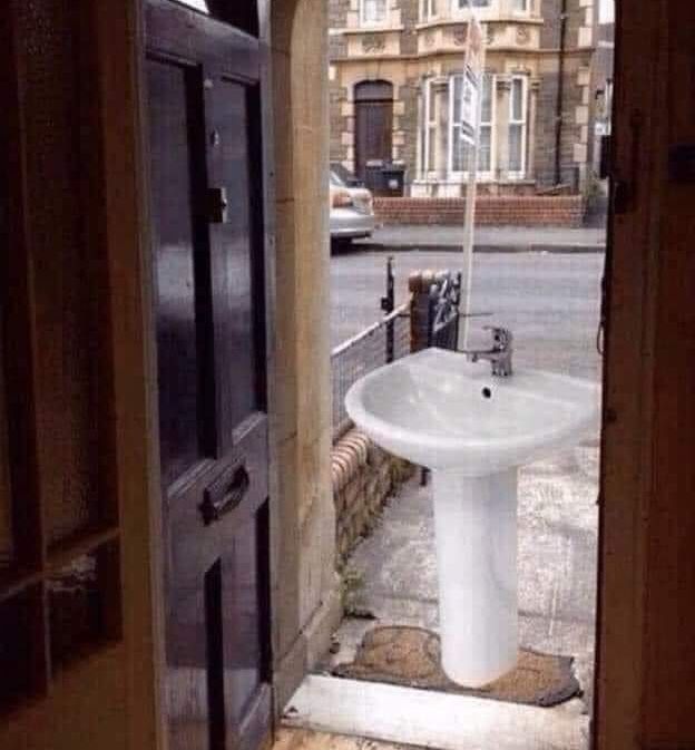 A picture of a sink waiting on the doorstep 