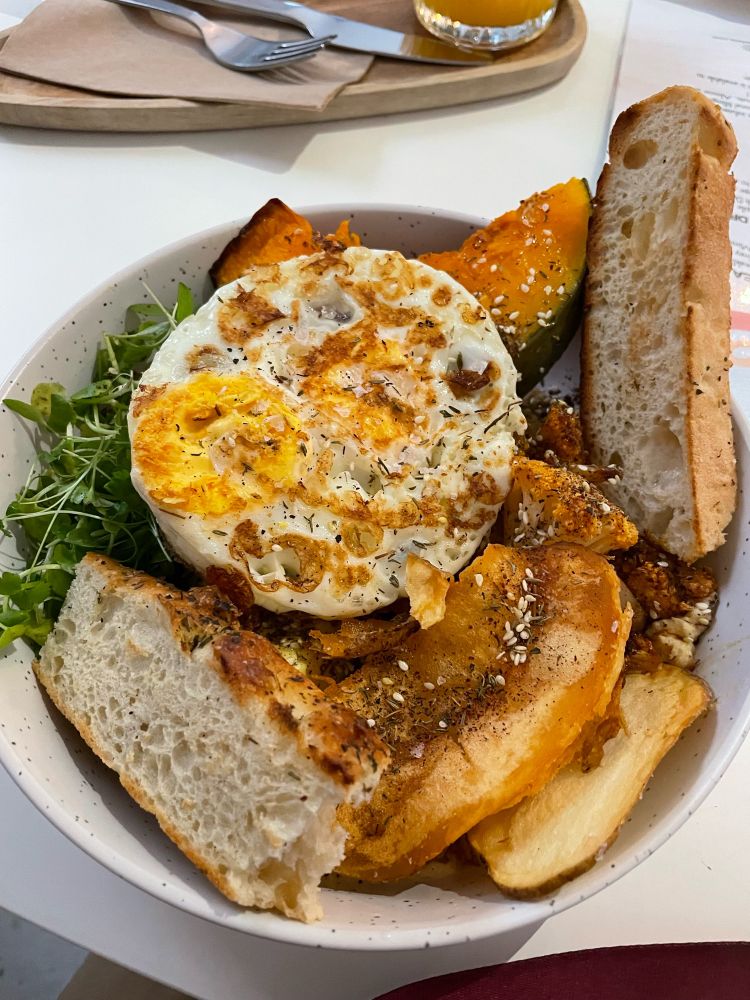 Fried egg, roasted squash, rocket, hummus, chick peas, roasted cauliflower, crispy fried potatoes, and sourdough for dipping yum