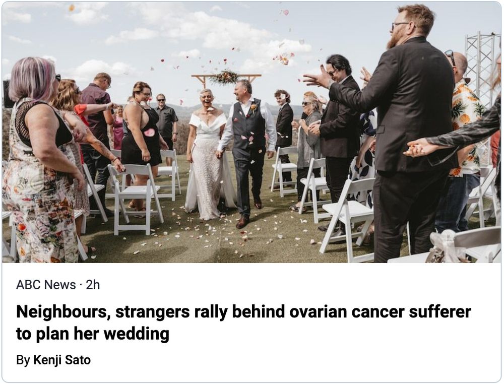 Happy bride and groom walk between guests at an outdoor wedding. 
ABC News article: Neighbours, strangers rally behind ovarian cancer sufferer to plan her wedding
