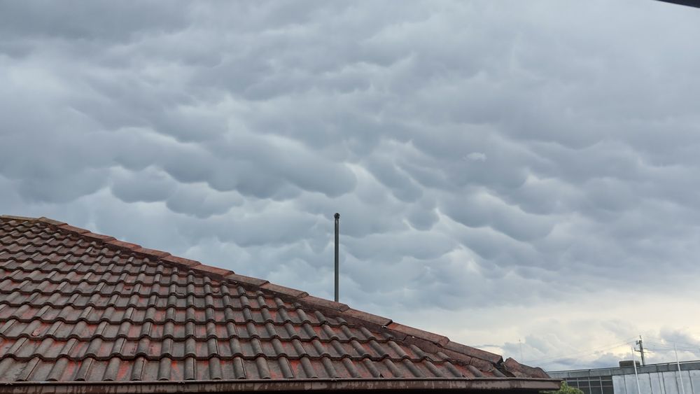 Mammatus clouds over a rooftop