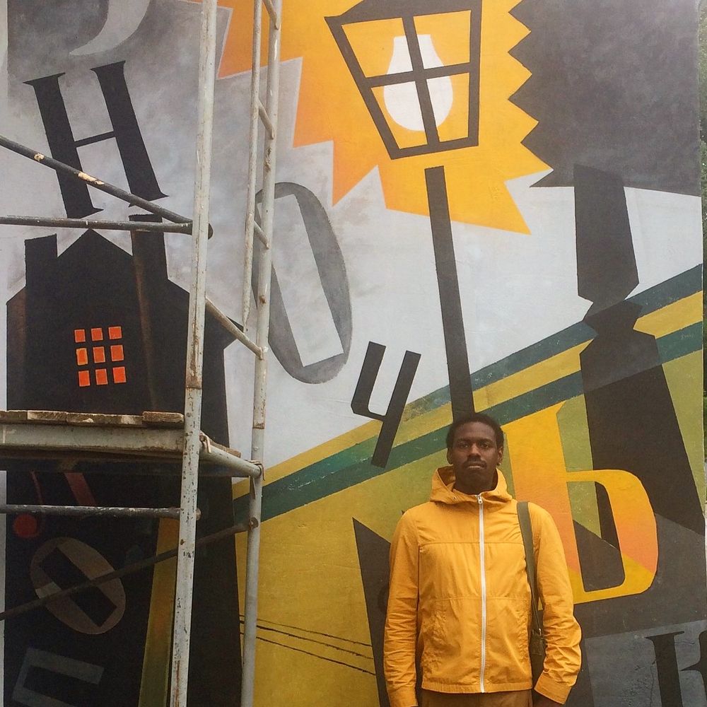 Anthony Russell standing in front of a Russian Suprematist-style mural in Vitebsk, Belarus.