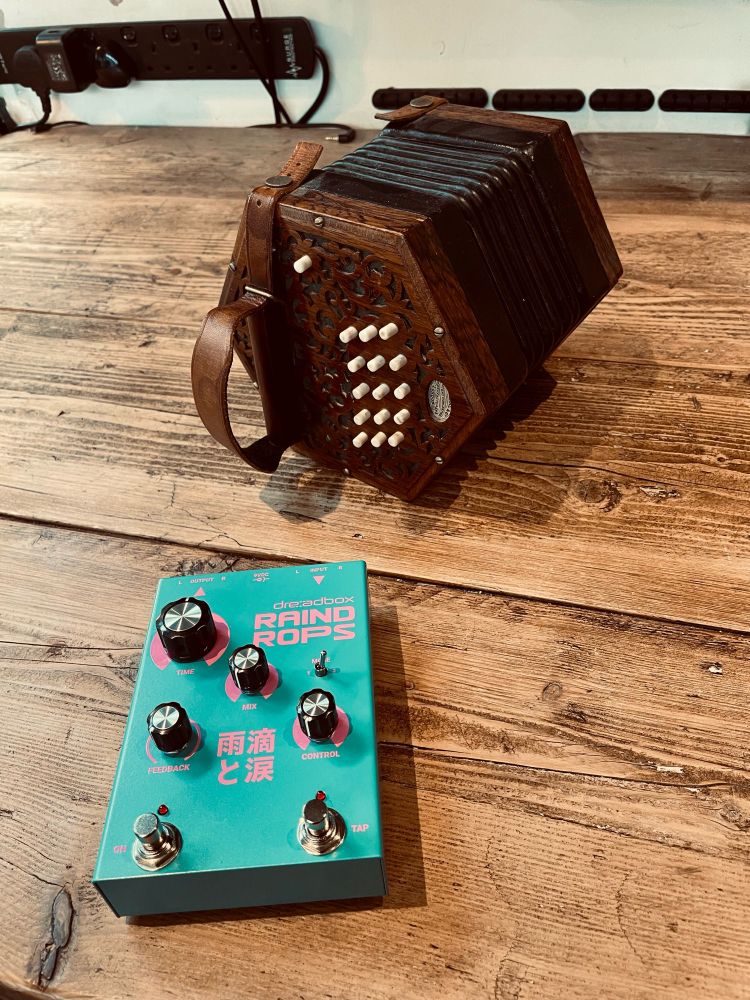 Lachenal 30-button anglo concertina alongside a Dreadbox Raindrops delay effects pedal.