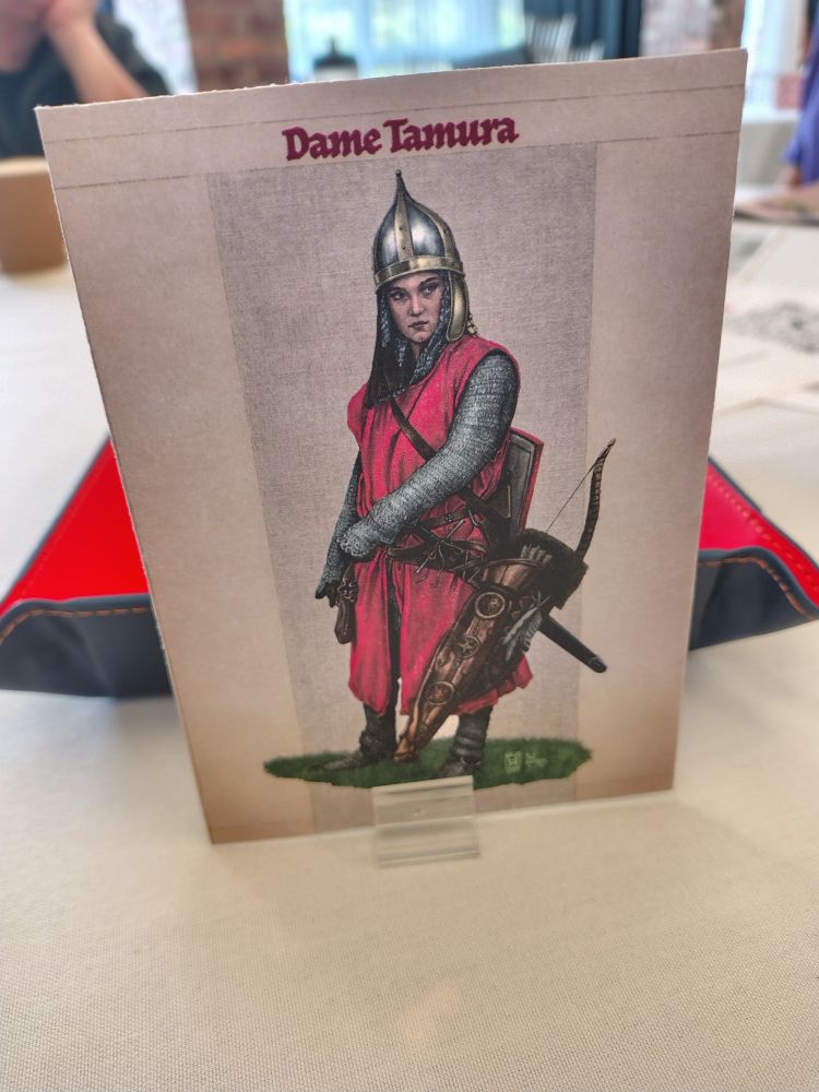 A standee of Dame Tamura in her pointy helmet and maille.