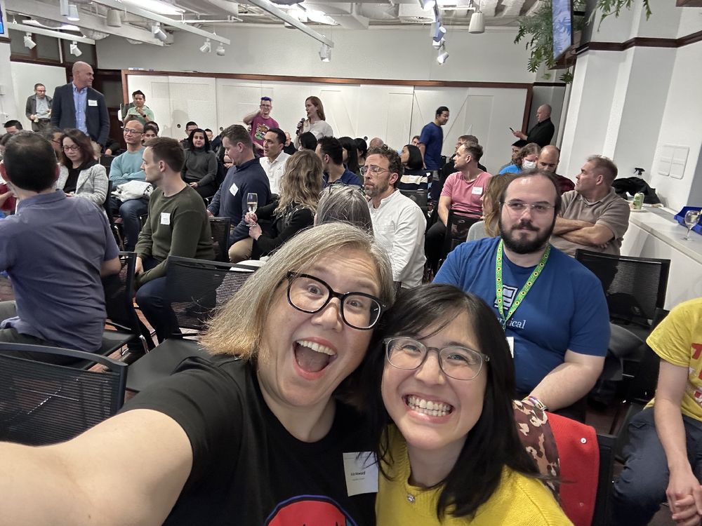 A selfie of two smiling women at a tech event