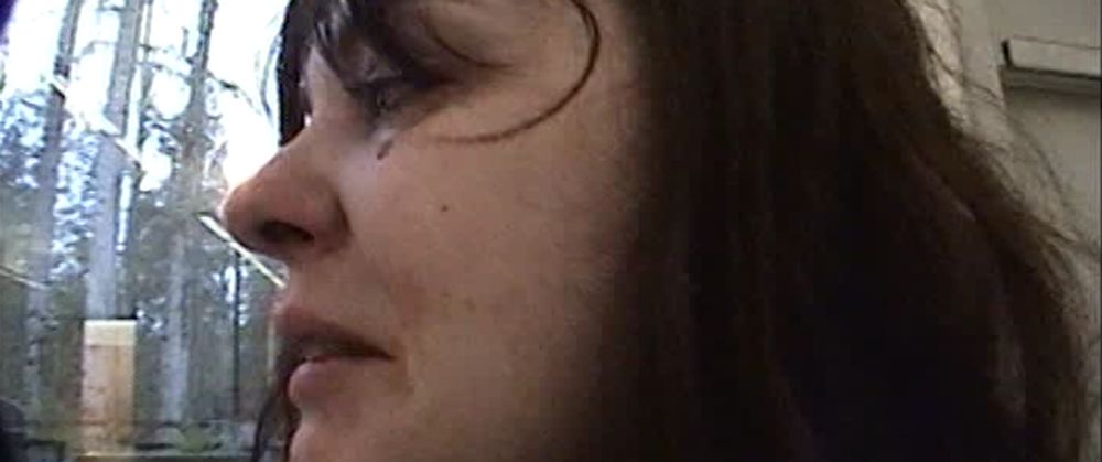 dionne copland as tommy in castration movie, close up shot as a tear runs down her bloody face