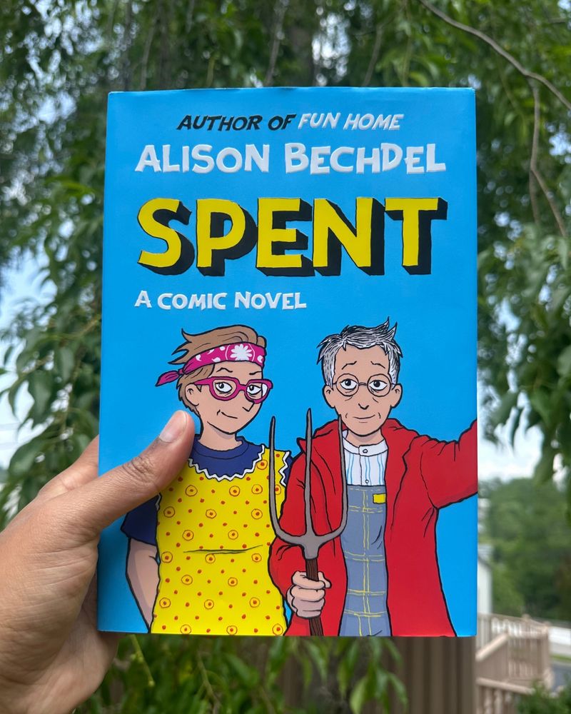 A blue book cover with large cartoon letters and a cartoon image of two people.