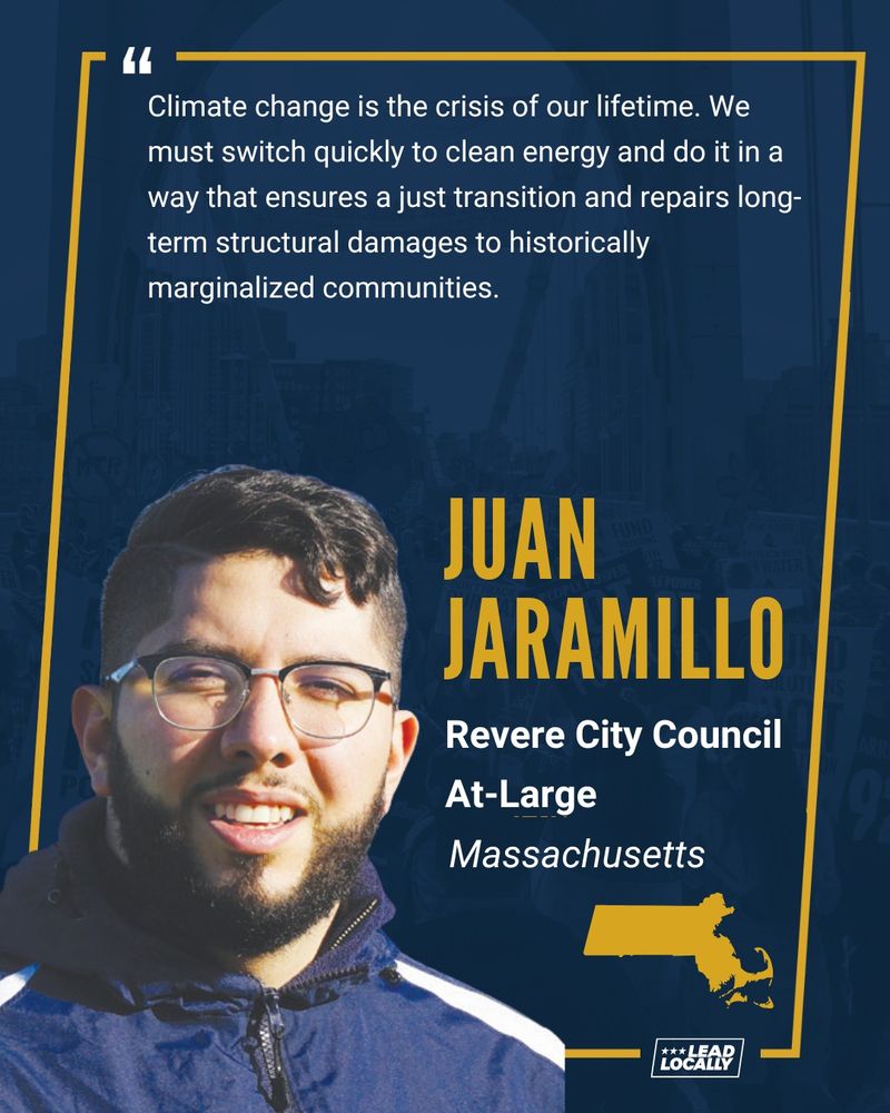 A man with black hair and a beard is looking at the camera