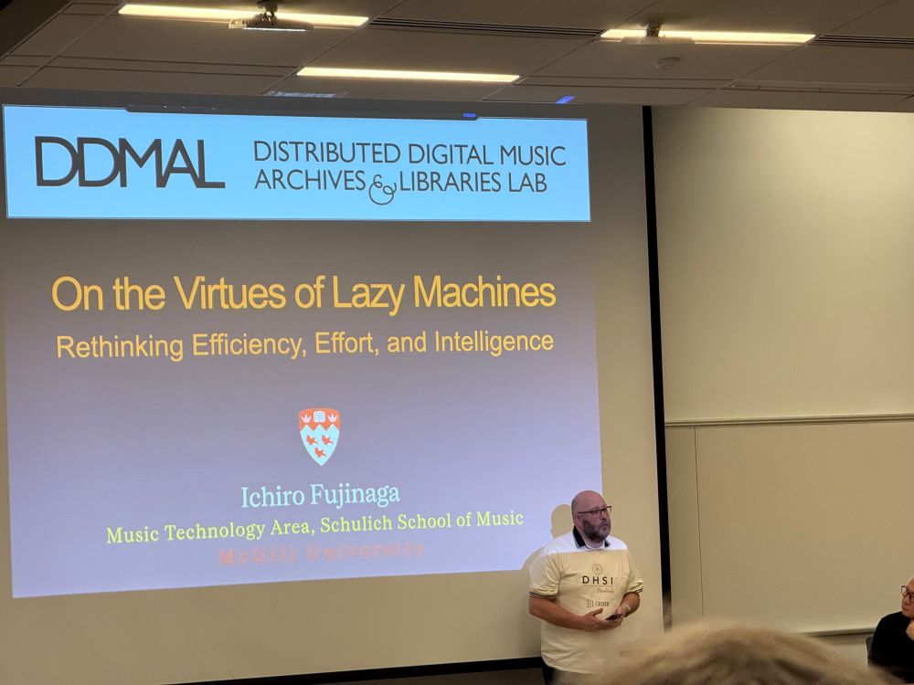 First DHSI lecture being delivered by Ichiro Fujinaga. Title slide reads “On the Virtues of Lazy Machinrs: Rethinking Efficiency, Effort, and Intelligence”