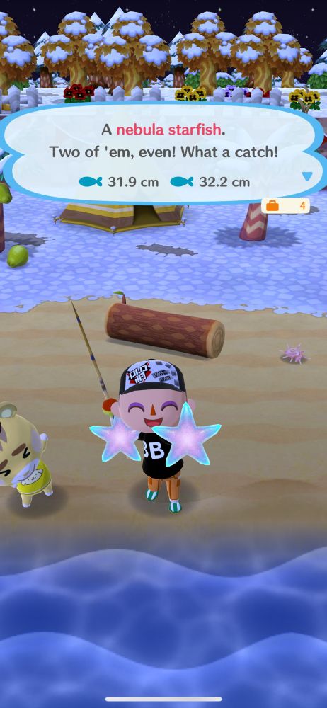 Screenshot from Animal Crossing: Pocket Camp. The player character is holding two freshly caught nebula starfish.