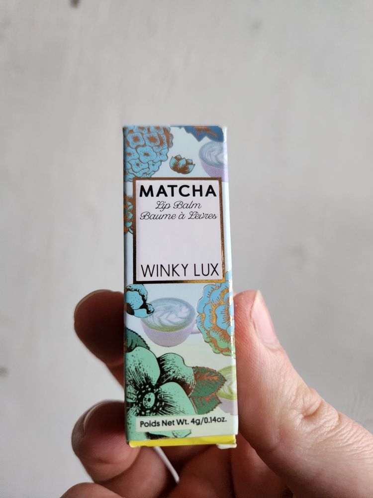 The pretty floral packaging for Winky Lux Matcha lip balm.