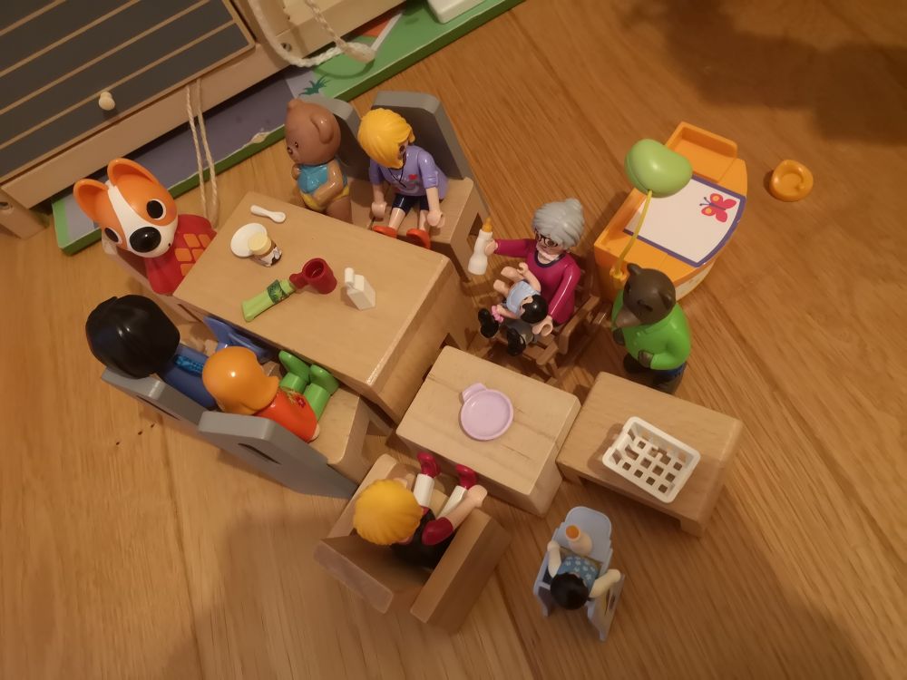 Mise en scène par le ouistiti : des personnages de toutes sortes, principalement playmobil, attablés sur des meubles de maison de poupée, quelques accessoires type lait, assiette, cuillère, mug, sur la table. Un moment ricoré. 
