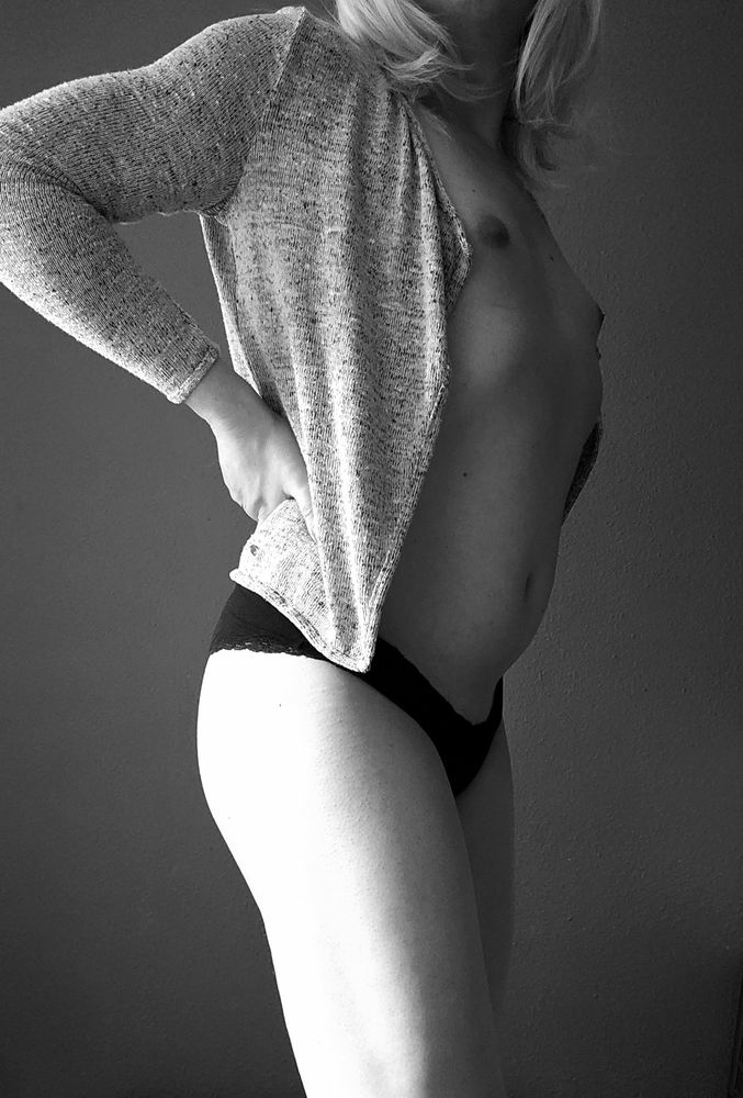 Vikky in black panties and a grey cardigan showing her tits