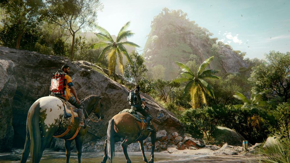 Two armed riders on horseback wade through a shallow stream in a lush tropical jungle, surrounded by palm trees and rocky terrain. Sunlight filters through the trees, illuminating a towering, foliage-covered mountain in the background.