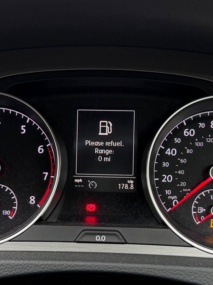 A fuel gauge reads 0 miles. 