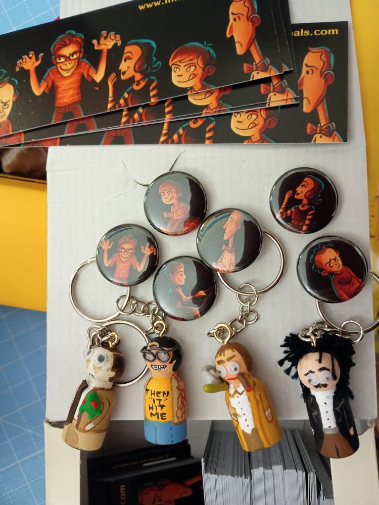 Some leftover Midnight Pals merchandise, including bookmarks and button badges with Michael Ramstead's cover art, and key fob peg dolls of Lovecraft, King, Highsmith and Poe, which I will be giving away indiscriminately at Hubfest 