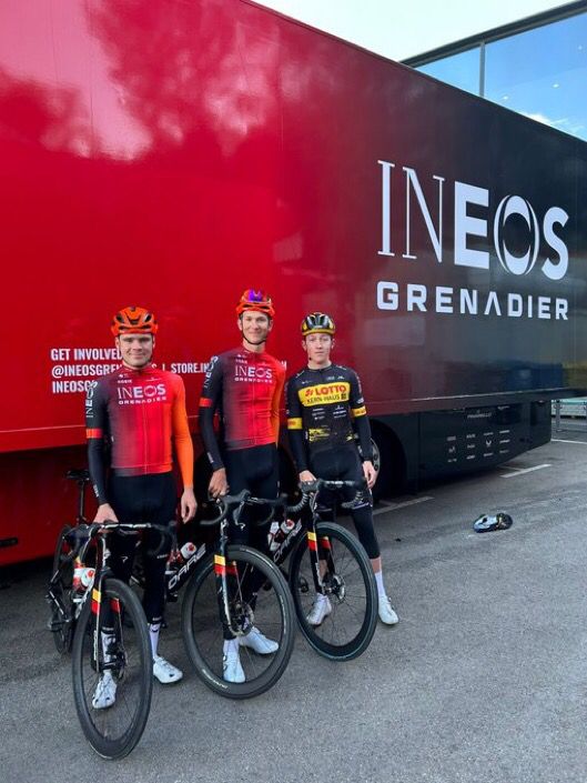 Joe with team mates in front of an Ineos team bus.
